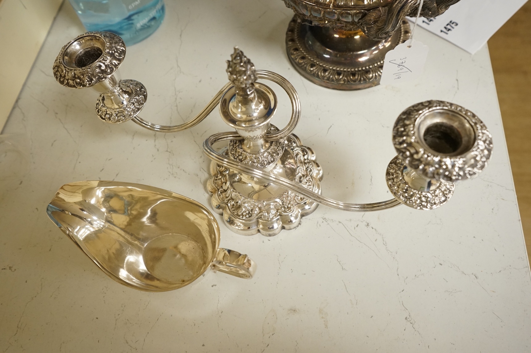 A group of sundry plated items including dwarf candelabra, a pair of wine coasters, a pair of grape shears, etc., and a quantity of assorted ivorine handled table and dessert knives.